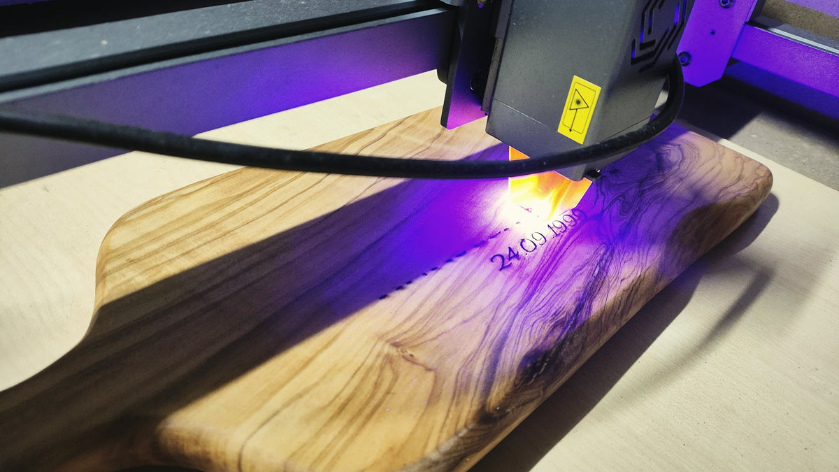 Laser engraving a personalised date on an olive wood cutting board