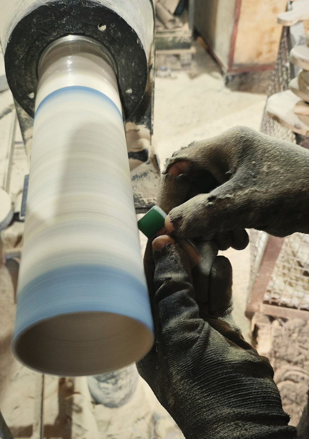 Artisan sanding a handmade olive wood piece on the lathe